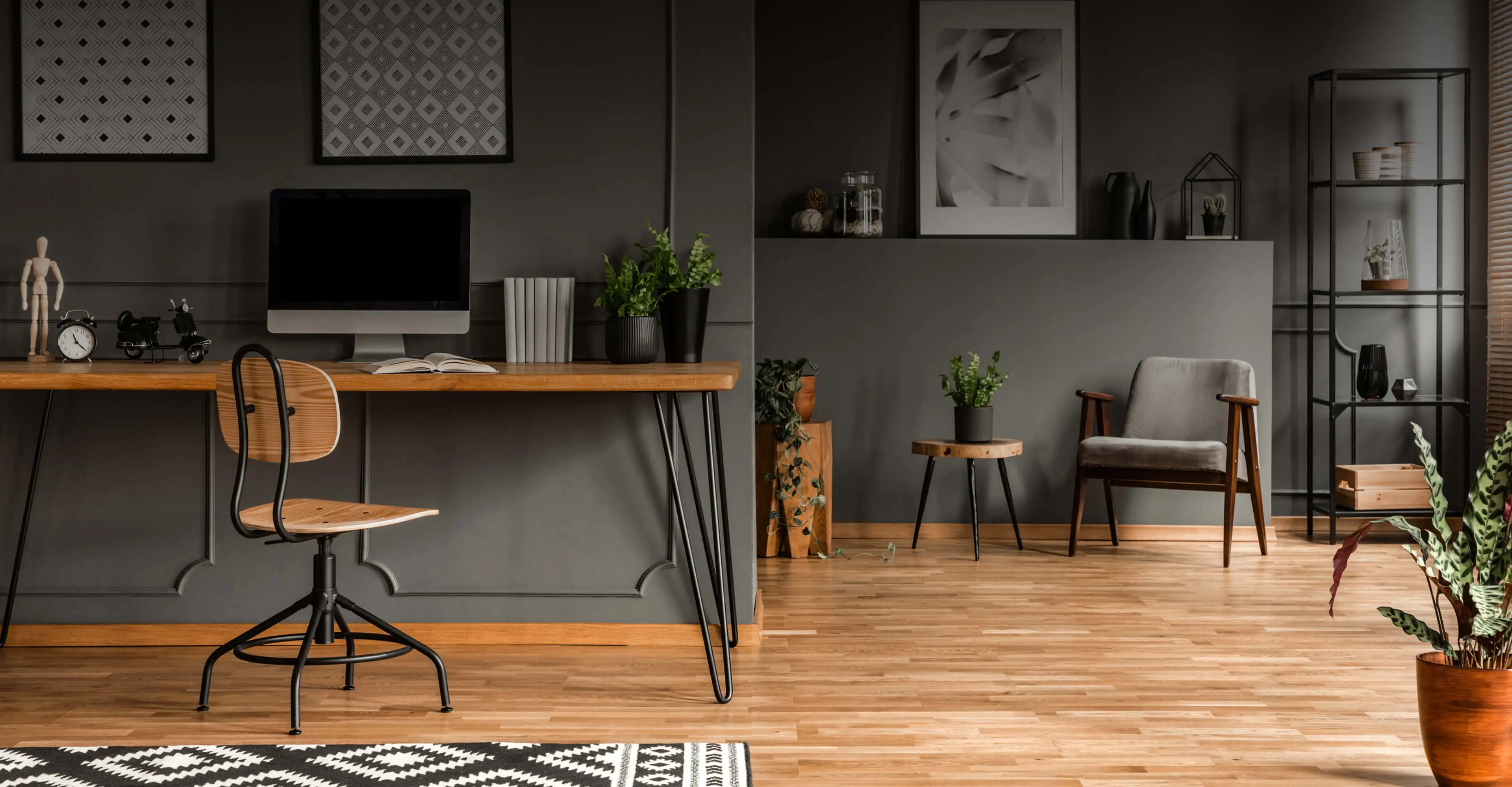 A wide view of a modern room with wood flooring.