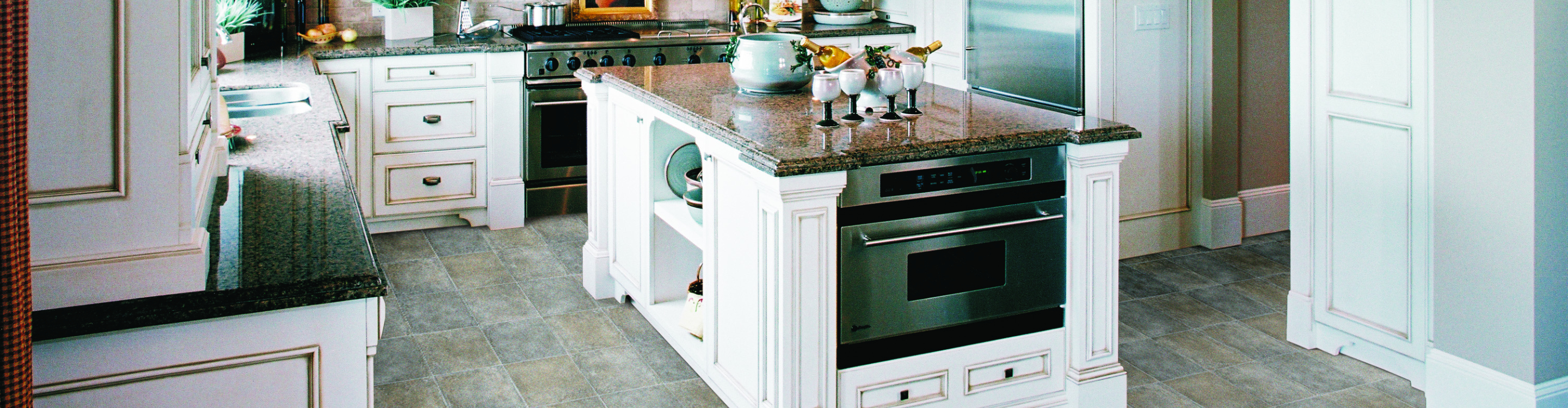 White quartz counter with island seating. 